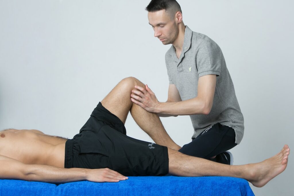 Doctor examining a patient's knee joint for pain